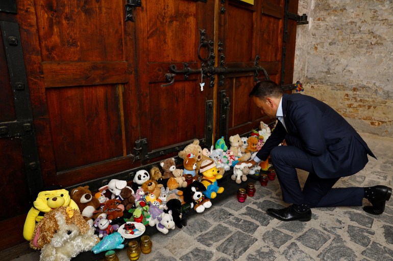 Ireland’s Prime Minister (Taoiseach) Leo Varadkar places a toy lamb at a memorial for the children who died in the conflict, amid Russia's attack on Ukraine, in Kyiv