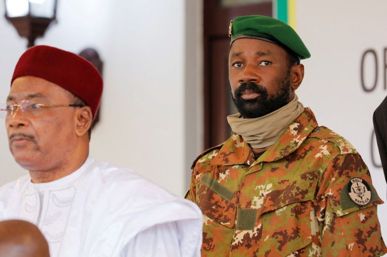 Colonel Assimi Goita, leader of Malian military junta, looks on while he stands behind Niger's President Mahamadou Issoufou during a photo opportunity after the Economic Community of West African States (ECOWAS) consultative meeting in Accra, Ghana September 15, 2020.