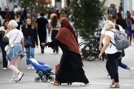 A Muslim woman, wearing the style of dress called an abaya, walks in a street in Nantes, France, August 29, 2023. REUTERS/Stephane Mahe