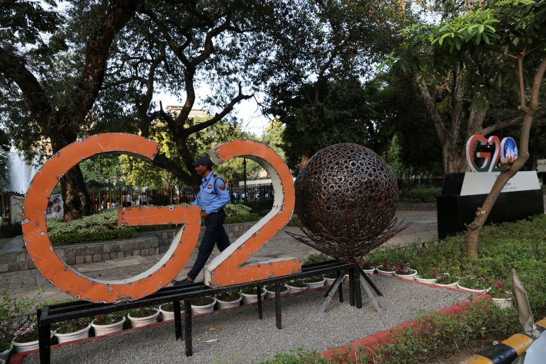 A security guard walks past a model of the G20 logo outside a park ahead of the G20 Summit in New Delhi, India, September 4, 2023. REUTERS/Anushree Fadnavis
