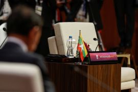 Myanmar's empty chair. The chair is white and there's a Myanmar flag and name plate on it.
