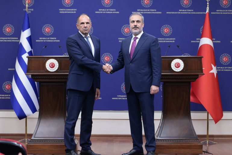 Turkish Foreign Minister Hakan Fidan shakes hands with his Greek counterpart George Gerapetriti