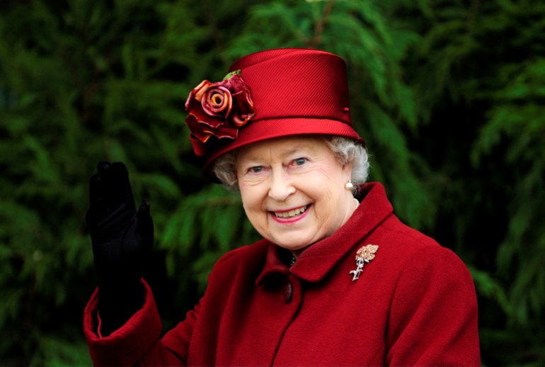 Britain's Queen Elizabeth II waves as she arrives for the final day of the Cheltenham Festival horse racing meeting in Gloucestershire, western England