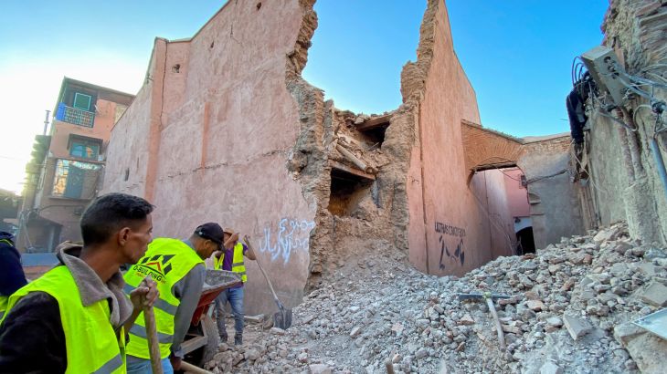 People work next to damage in the historic city of Marrakech, following a powerful earthquake in Morocco