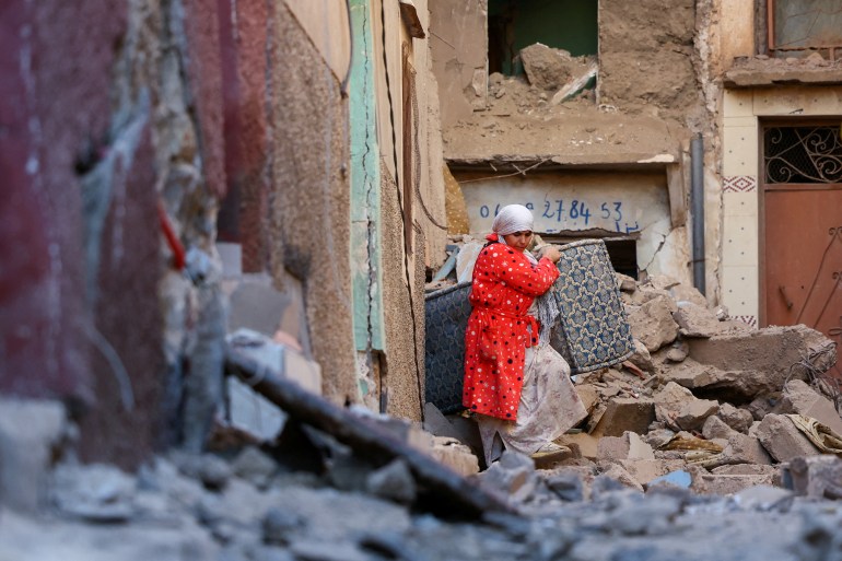 A woman carries items from a damaged building, after a deadly earthquake in Moulay Brahim, Morocco, September 10, 2023. REUTERS/Hannah McKay TPX IMAGES OF THE DAY