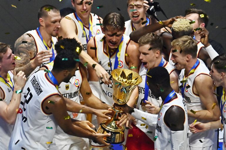 Germany players celebrate with the trophy after winning the FIBA World Cup 2023
