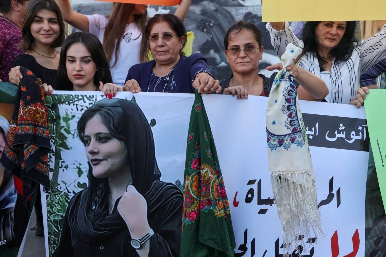 Women hold a picture of Mahsa Amini during a sit-in following her death, at Martyrs' Square in Beirut, Lebanon September 21, 2022
