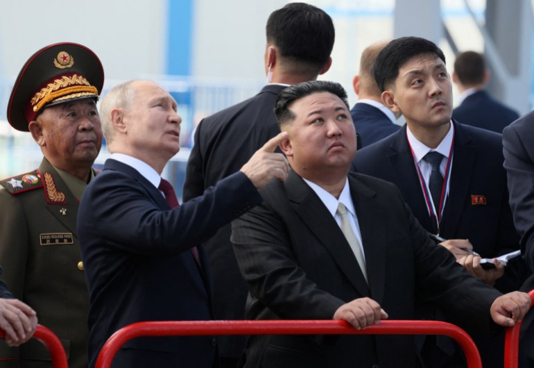 Putin pointing something out to Kim as they tour the Vostochny Сosmodrome.