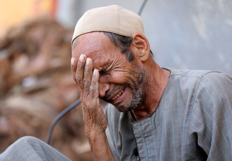 Hassan El Salheen, weeps after burying the repatriated body of his son, Aly,