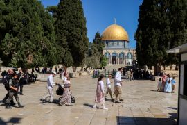 Israeli police escort visitors as they tour the Al-Aqsa compound