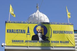 A sign outside the Guru Nanak Sikh Gurdwara temple is seen after the killing on its grounds