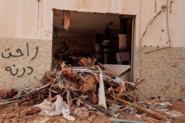 Graffiti that reads "Derna is gone" is seen on a damaged shop wall in the aftermath of the deadly storm that hit Libya, in Derna, Libya September 21, 2023.