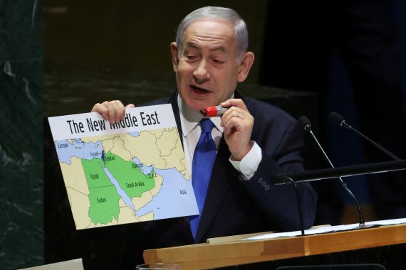Benjamin Netanyahu holding up a map of the Middle East