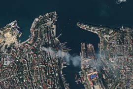 A satellite image shows smoke billowing from Russia&#39;s Black Sea Fleet headquarters after the missile strike [Planet Labs Pbc via Reuters]