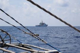 A China Coast Guard ship seen from a Philippine fishing boat at disputed Scarborough Shoal [File: Erik De Castro/Reuters]