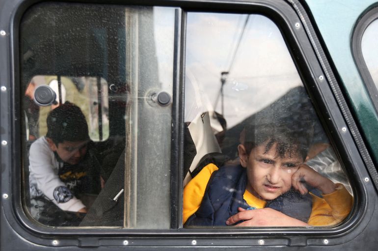 A refugee boy from Nagorno-Karabakh region looks out of a car window upon arrival at a temporary accommodation centre in the town of Goris, Armenia, September 25, 2023. REUTERS/Irakli Gedenidze TPX IMAGES OF THE DAY