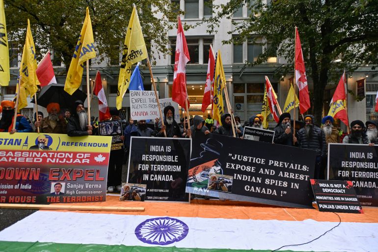 Kanada Başbakanı Justin Trudeau'nun, Sih ayrılıkçı lider Hardeep Singh Nijjar'ın Vancouver, British Columbia, Kanada'da öldürülmesinde Yeni Delhi'nin parmağı olduğu ihtimalini gündeme getirmesinden bir hafta sonra, ellerinde bayraklar ve pankartlar taşıyan göstericiler, 25 Eylül 2023'te Kanada'nın Vancouver kentinde düzenlenen Hindistan konsolosluğu önünde protesto düzenledi. REUTERS/ Jennifer Gauthier
