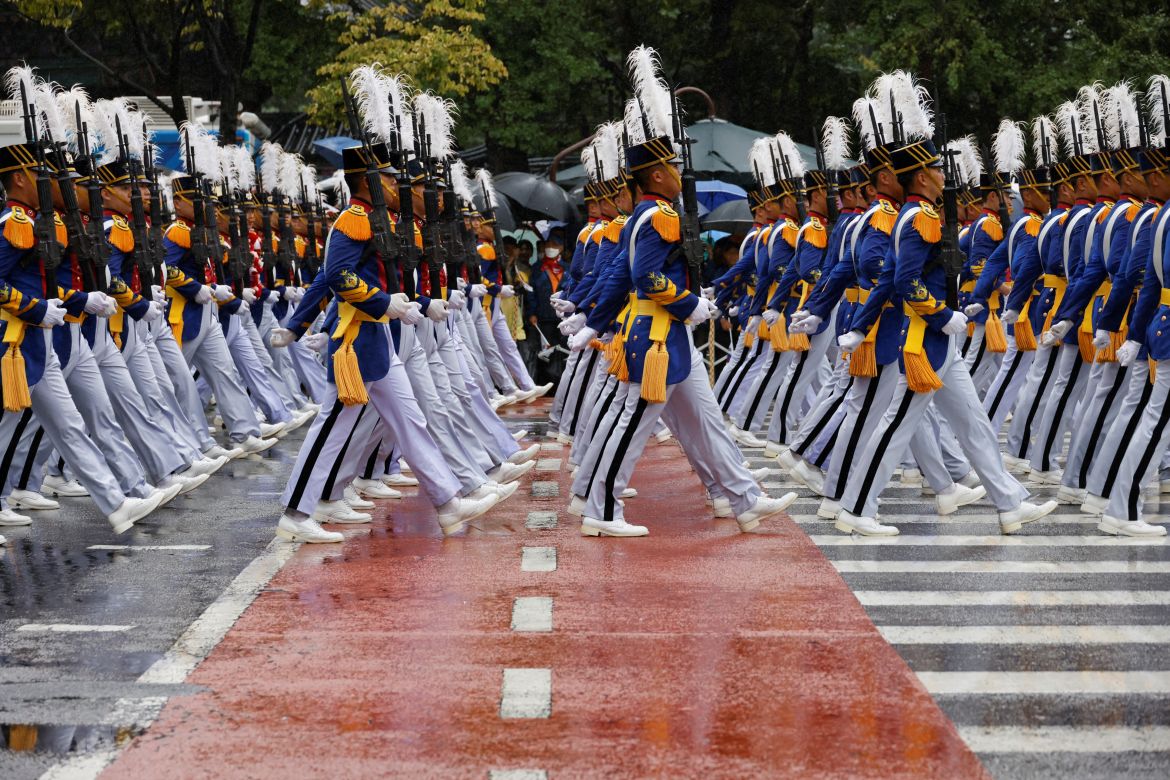 Soldiers in ceremonial uniform take part in the parade. They have white plumes in their hats.