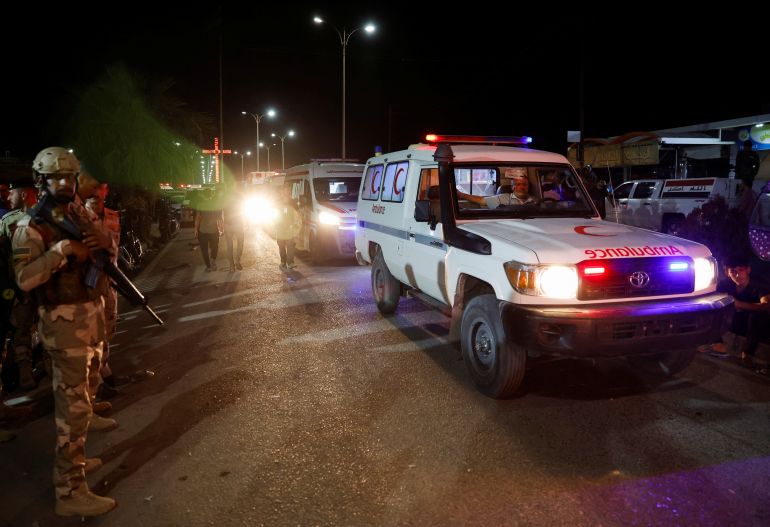 Security forces keep watch next to ambulances near a hospital following a fatal fire at a wedding celebration, in Iraq's Nineveh province, Iraq, September 27, 2023. REUTERS/Khalid Al-Mousily