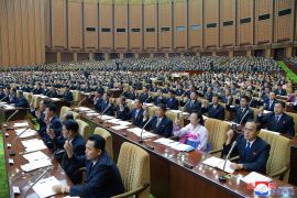 Rows of representatives in North Korea's rubber-stamp parliament are seen attending a meeting.