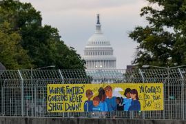 A view of a working families poster as the U.S. Capitol is seen in the background, as the deadline to avert a partial government shutdown approaches at the end of the day on Capitol Hill in Washington, U.S., September 30, 2023.