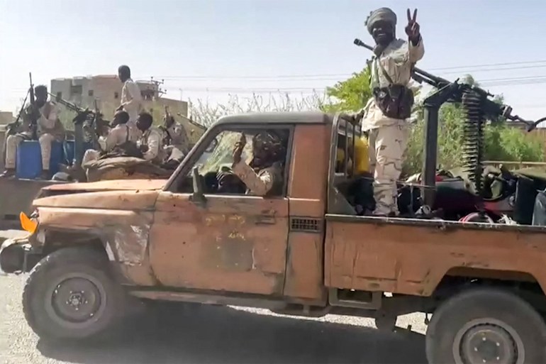 In this image grab taken from handout video footage released by the Sudanese paramilitary Rapid Support Forces (RSF) on April 23, 2023, fighters ride in the back of a technical vehicle (pickup truck mounted with a turret) in the East Nile district of greater Khartoum. A US-brokered ceasefire between Sudan's warring generals entered its second day on April 26, 2023, but remained fragile after witnesses reported fresh air strikes and paramilitaries claimed to have seized a major oil refinery and power plant. (Photo by Rapid Support Forces (RSF) / AFP) / === RESTRICTED TO EDITORIAL USE - MANDATORY CREDIT "AFP PHOTO / HO / SUDAN RAPID SUPPORT FORCES (RSF)" - NO MARKETING NO ADVERTISING CAMPAIGNS - DISTRIBUTED AS A SERVICE TO CLIENTS === - === RESTRICTED TO EDITORIAL USE - MANDATORY CREDIT "AFP PHOTO / HO / SUDAN RAPID SUPPORT FORCES (RSF)" - NO MARKETING NO ADVERTISING CAMPAIGNS - DISTRIBUTED AS A SERVICE TO CLIENTS === / BEST QUALITY AVAILABLE