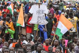 A supporter holds a t-shirt reading &#34;France Must Go&#34; as supporters of Niger&#39;s National Council of Safeguard of the Homeland (CNSP) protest outside the Niger and French airbase in Niamey on September 2, 2023 to demand the departure of the French army from Niger. (Photo by - / AFP) (AFP)