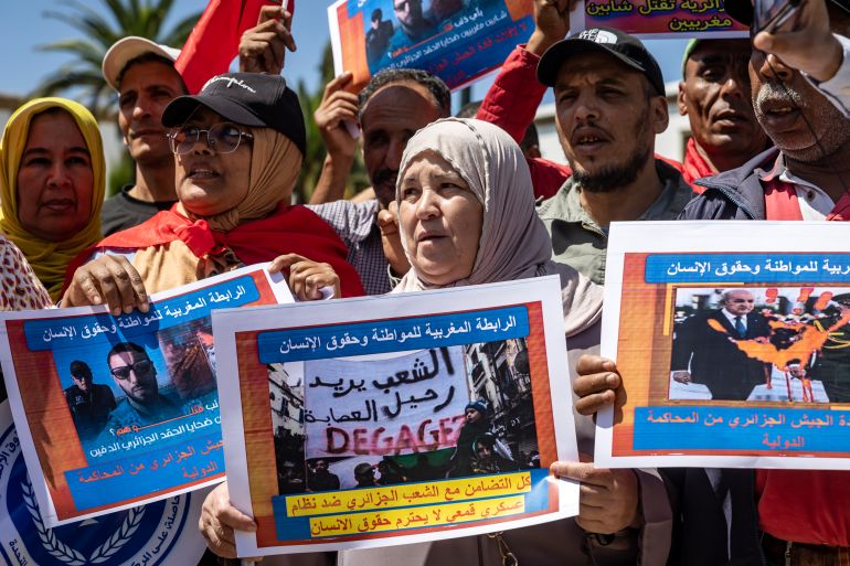 Moroccans carry posters during a demonstration in Rabat on September 4, 2023, condemning the killing of two jet skiers by the Algerian coastguard