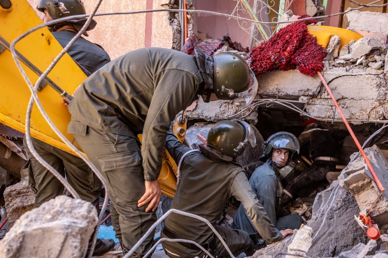 Rescue workers search for survivors in a collapsed house in Moulay Brahim, Al Haouz province, on September 9, 2023.