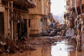Overturned cars lay among other debris caused by flash floods in Derna, eastern Libya on September 11, 2023 [AFP]