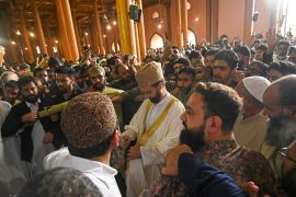 Senior separatist leader Mirwaiz Umar Farooq, centre, arrives to deliver the Friday sermon at Jamia Masjid in downtown Srinagar [Tauseef Mustafa/AFP]
