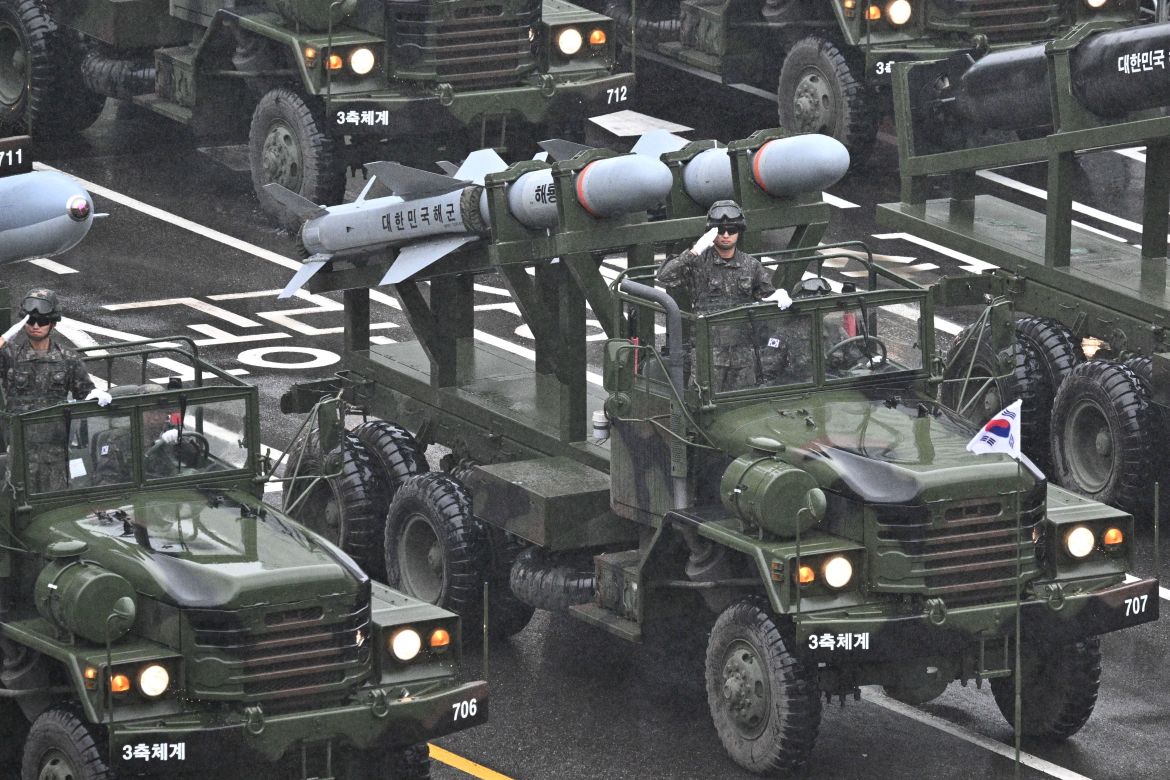 Military vehicles carrying rockets driving through Seoul as part of the parade.
