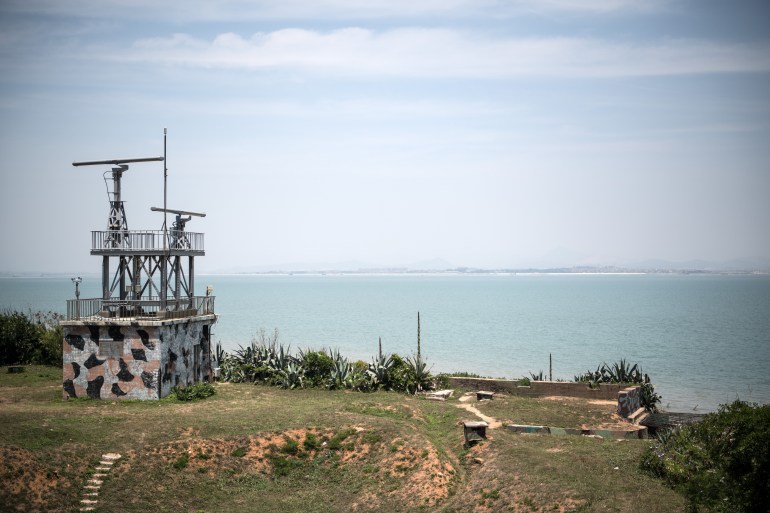 A photo of a radar station on a clifftop with the ocean below.