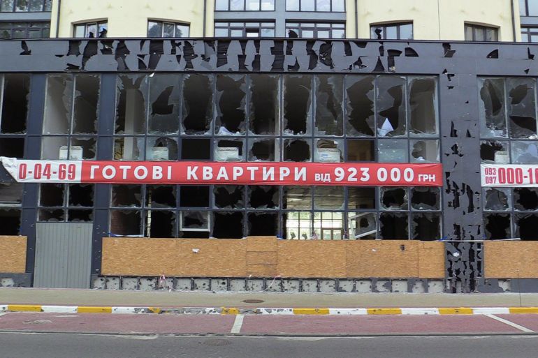 A sign saying 'Completed apartments' on the damaged building in Irpin north of Kyiv