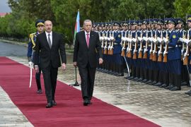 Turkish President Recep Tayyip Erdogan, right, is welcomed by Azerbaijani President Ilham Aliyev, left, and an honour guard in Nakhchivan on September 25, 2023 [Arif Hudaverdi Yaman/Anadolu Agency]