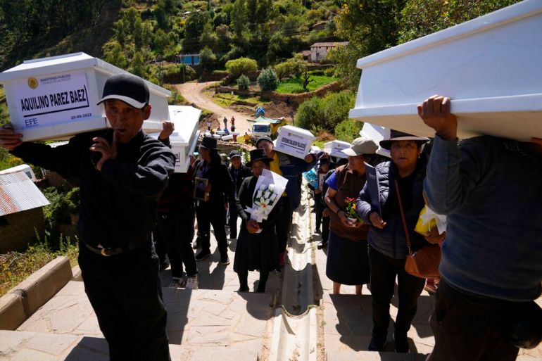 A funeral procession carries the remains of loved ones lost during Peru's period of civil conflict in the 1980s and 1990s