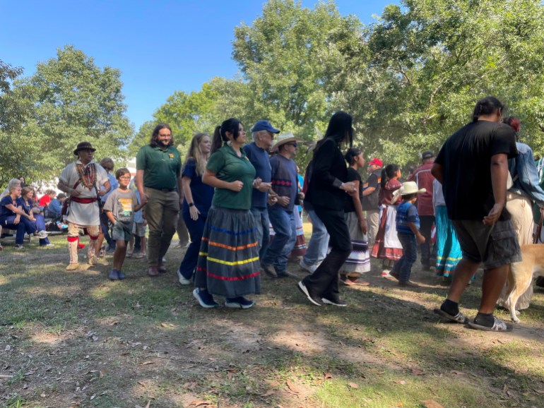 People line up to dance outdoors at the Ocmulgee National Park and Preserve Initiative