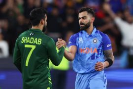 Kohli shakes hands with Pakistan&#39;s Shadab Khan during the T20 World Cup match between India and Pakistan in Australia [File: Asanka Brendon Ratnayake/AP]