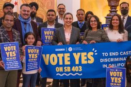 Aisha Wahab stands with supporters of SB 403