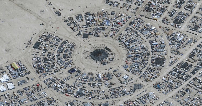 In this satellite photo provided by Maxar Technologies, an overview of Burning Man festival in Black Rock