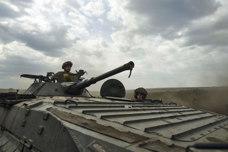 Soldiers of Ukraine's 3rd Separate Assault Brigade ride an APC near Bakhmut, the site of fierce battles with the Russian forces in the Donetsk region, Ukraine, Monday, Sept. 4, 2023. (AP Photo/Libkos)