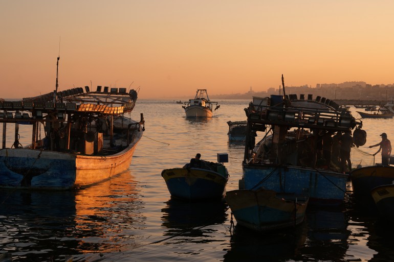 Palestinian fishing boats return after a nighttime fishing trip to the seaport in Gaza City, Thursday, Sept. 7, 2023