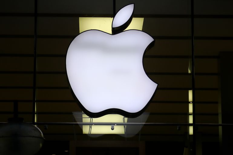 he Apple logo is illuminated at a store in the city center in Munich