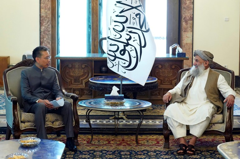 In this handout photo released by the Taliban Prime Minister Media Office, China's new ambassador to Afghanistan Zhao Sheng meets with Taliban Prime Minister Mohammad Hasan Akhund