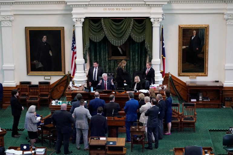 Texas Lieutenant Governor Dan Patrick talks to prosecution and defense attorneys after the prosecution rested in the impeachment trial for Texas Attorney General Ken Paxton in the Senate Chamber at the Texas Capitol, Wednesday, Sept. 13, 2023, in Austin, Texas.