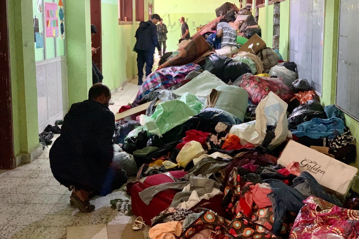People deliver donated clothes to a flash flood-destroyed city of Derna