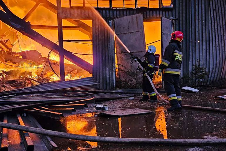 Firefighters at the scene of a blaze caused by a Russian attack on the city of Lviv