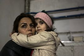 A girl embraces a relative in a shelter during shelling in Stepanakert, Nagorno-Karabakh. [Siranush Sargsyan/AP Photo]
