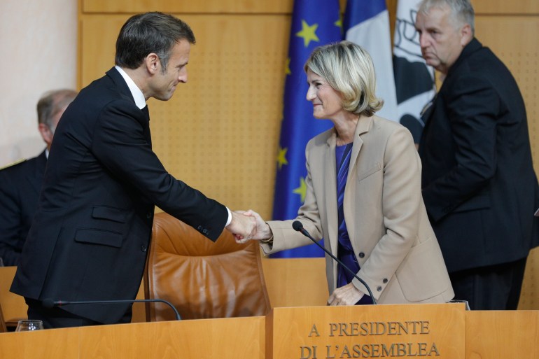 French President Emmanuel Macron shakes hands with Corsican Assembly president Marie-Antoinette Maupertuis before addressing the Corsican Assembly in Ajaccio