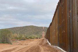 A section of border wall in the desert